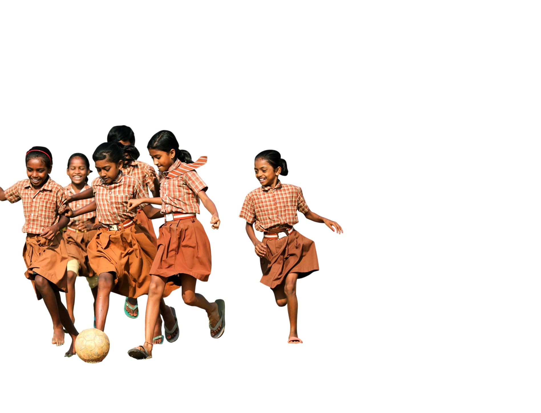 Five schoolgirls in checked uniforms running together as they play with a football.